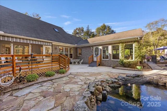 a living room with furniture a chandelier and a large window