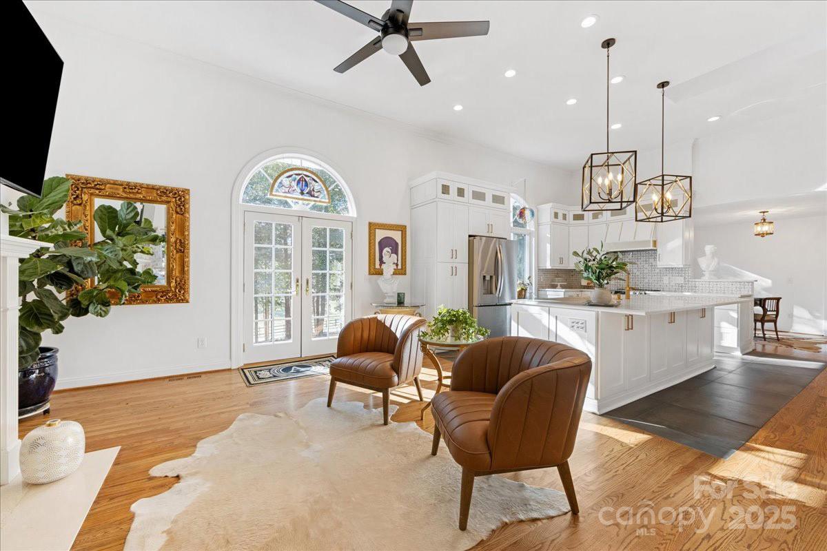 9701 Deer Run Road Waxhaw, NC 28173 - Photo 18 of 47 a living room with furniture a chandelier and a large window