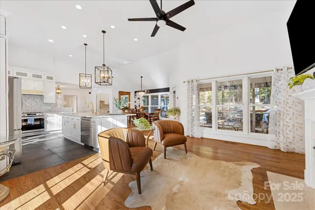 a kitchen with stainless steel appliances white cabinets and a stove top oven