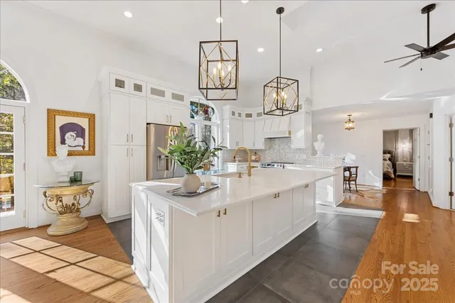 a kitchen with stainless steel appliances granite countertop a lot of counter space and wooden floor