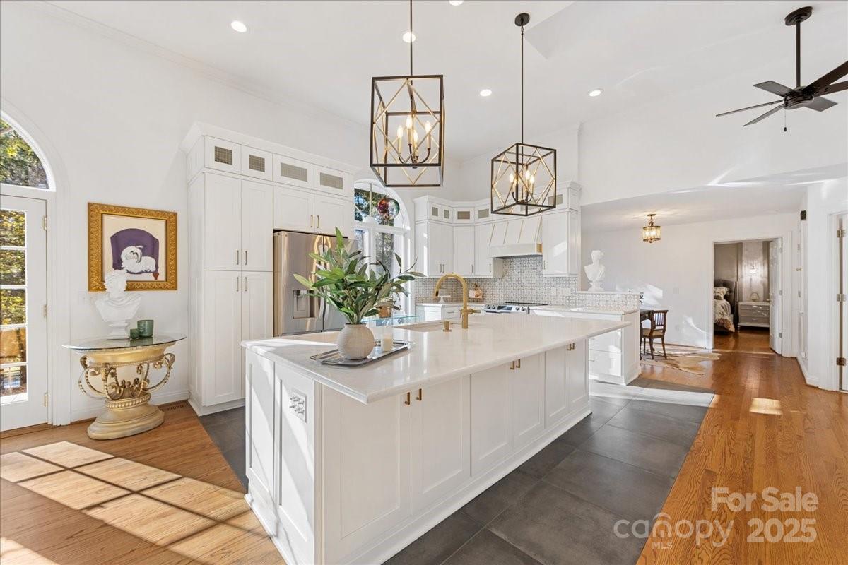 9701 Deer Run Road Waxhaw, NC 28173 - Photo 20 of 47 a large white kitchen with a sink and breakfast area