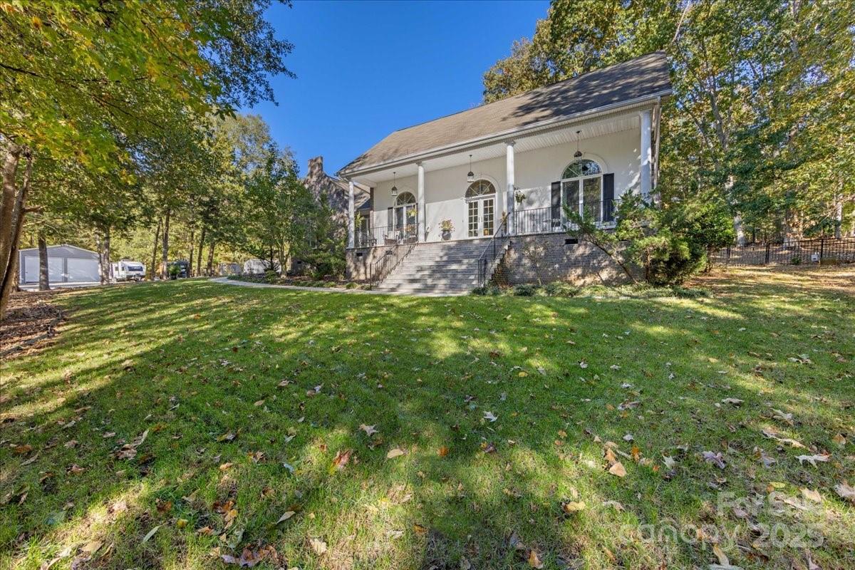 9701 Deer Run Road Waxhaw, NC 28173 - Photo 2 of 47 a front view of a house with a garden