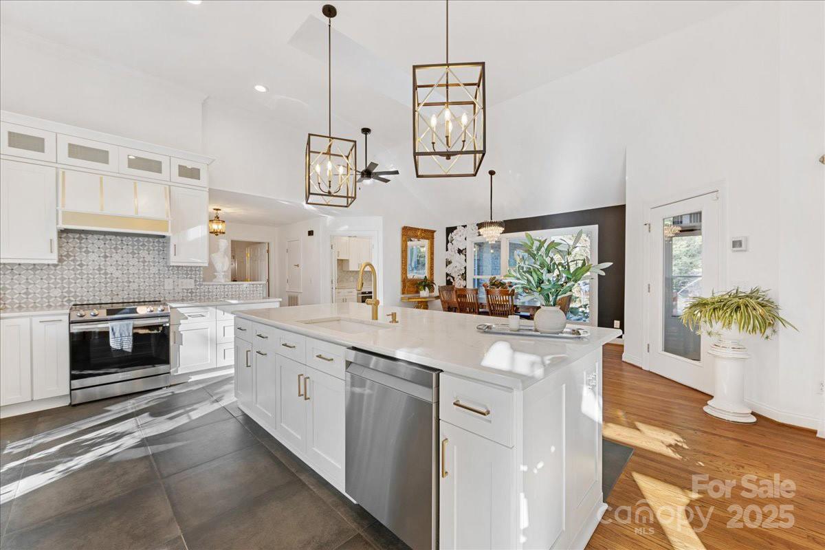 9701 Deer Run Road Waxhaw, NC 28173 - Photo 22 of 47 a kitchen with stainless steel appliances granite countertop a lot of counter space and wooden floor