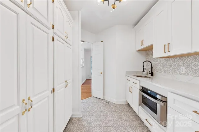 a bathroom with a toilet sink vanity and mirror