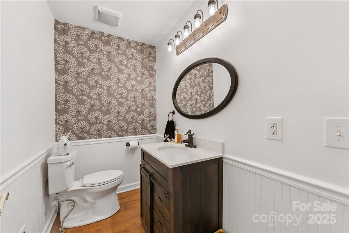 9701 Deer Run Road Waxhaw, NC 28173 - Photo 32 of 47 a bathroom with a toilet sink vanity and mirror