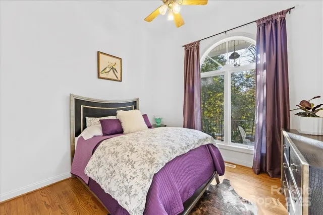 a bedroom with a large bed and a chandelier