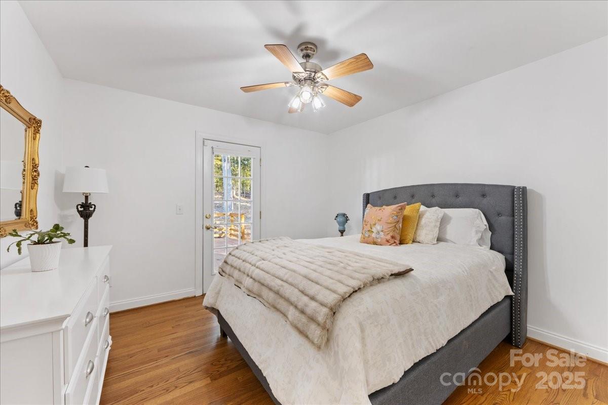 9701 Deer Run Road Waxhaw, NC 28173 - Photo 38 of 47 a bedroom with a large bed and a chandelier