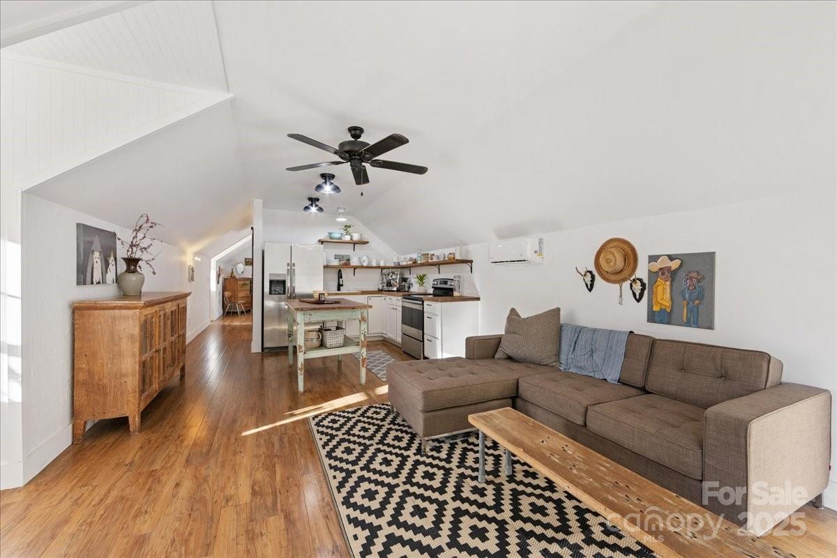 9701 Deer Run Road Waxhaw, NC 28173 - Photo 40 of 47 a living room with furniture and a wooden floor