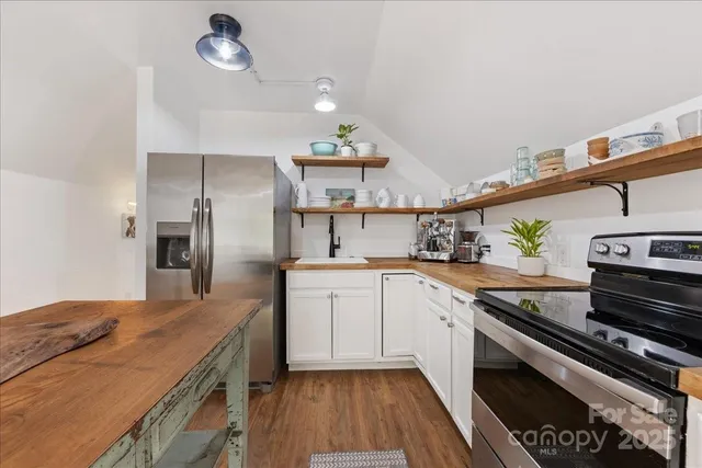 a bedroom with a bed dresser and a window