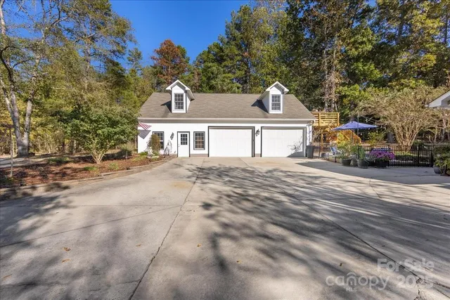 a view of a patio with couches and a table and chairs under an umbrella