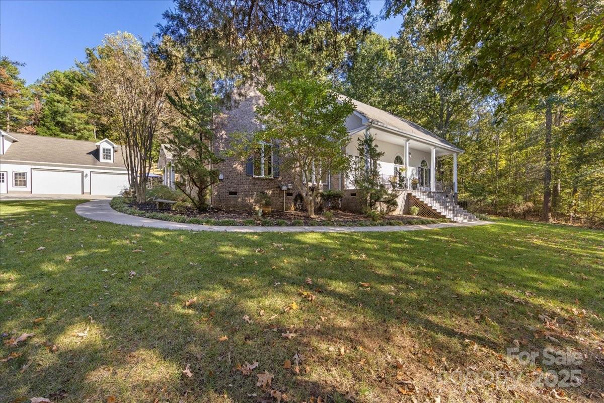 9701 Deer Run Road Waxhaw, NC 28173 - Photo 10 of 47 a front view of a house with garden