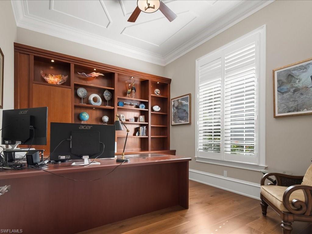 2822 Capistrano Way Naples, FL 34105 - Photo 17 of 47 Home office with extensive shelving, storage and wood flooring.