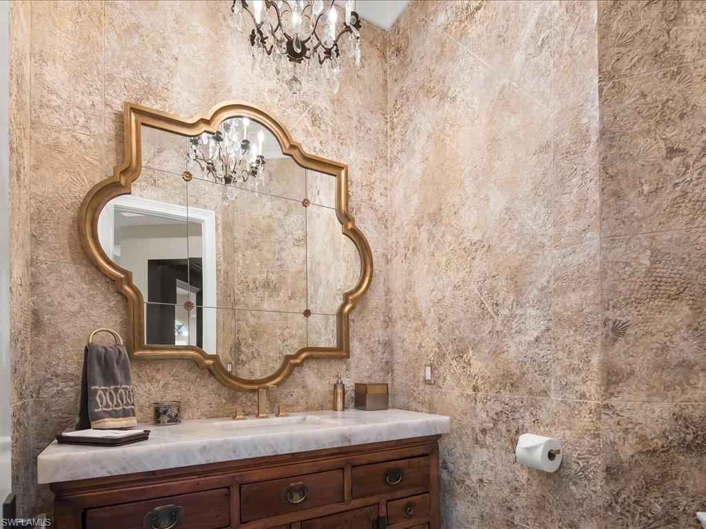2822 Capistrano Way Naples, FL 34105 - Photo 18 of 47 Powder room with faux painting, dramatic mirror and lighting.
