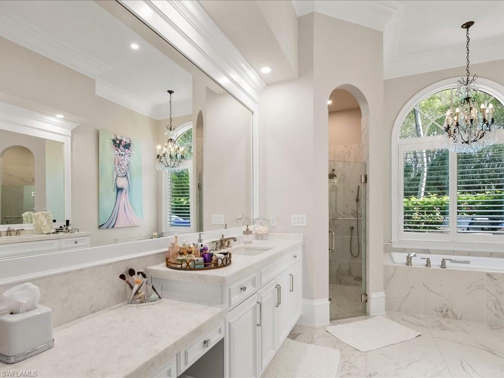 2822 Capistrano Way Naples, FL 34105 - Photo 26 of 47 Updated primary bathroom with dual sinks, separate shower and tub