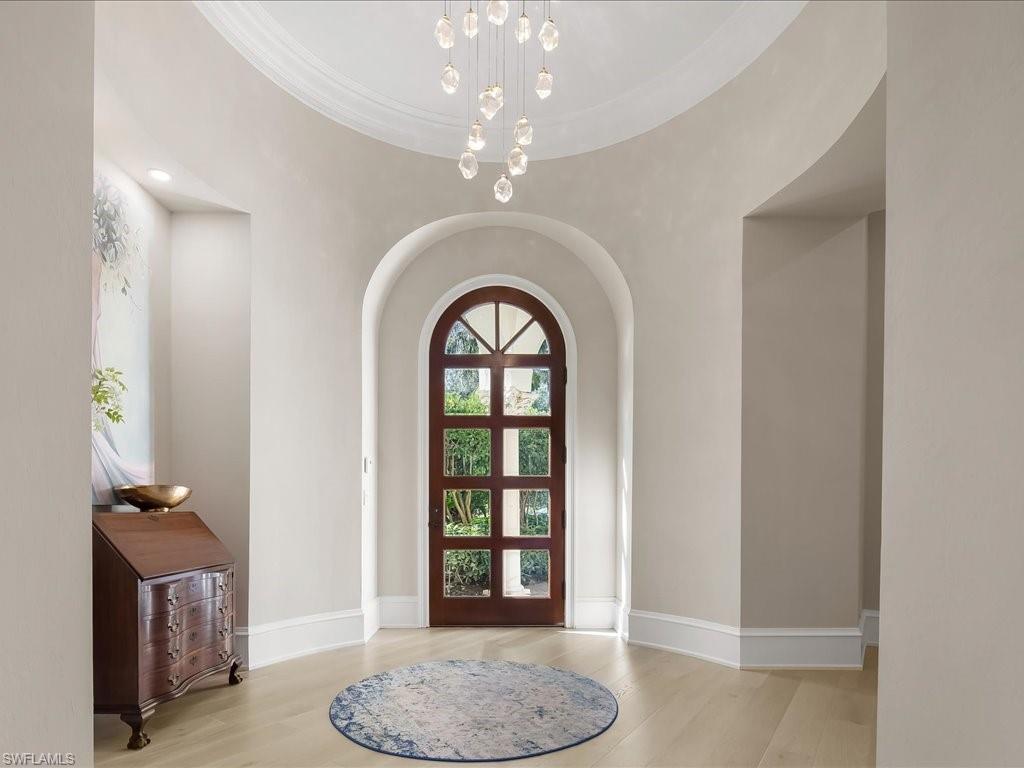 2822 Capistrano Way Naples, FL 34105 - Photo 3 of 47 Lovely arched entry to the home with striking light fixture