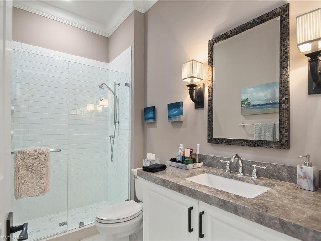 2822 Capistrano Way Naples, FL 34105 - Photo 32 of 47 Plush ensuite bathroom with walk in shower and lovely lighting.