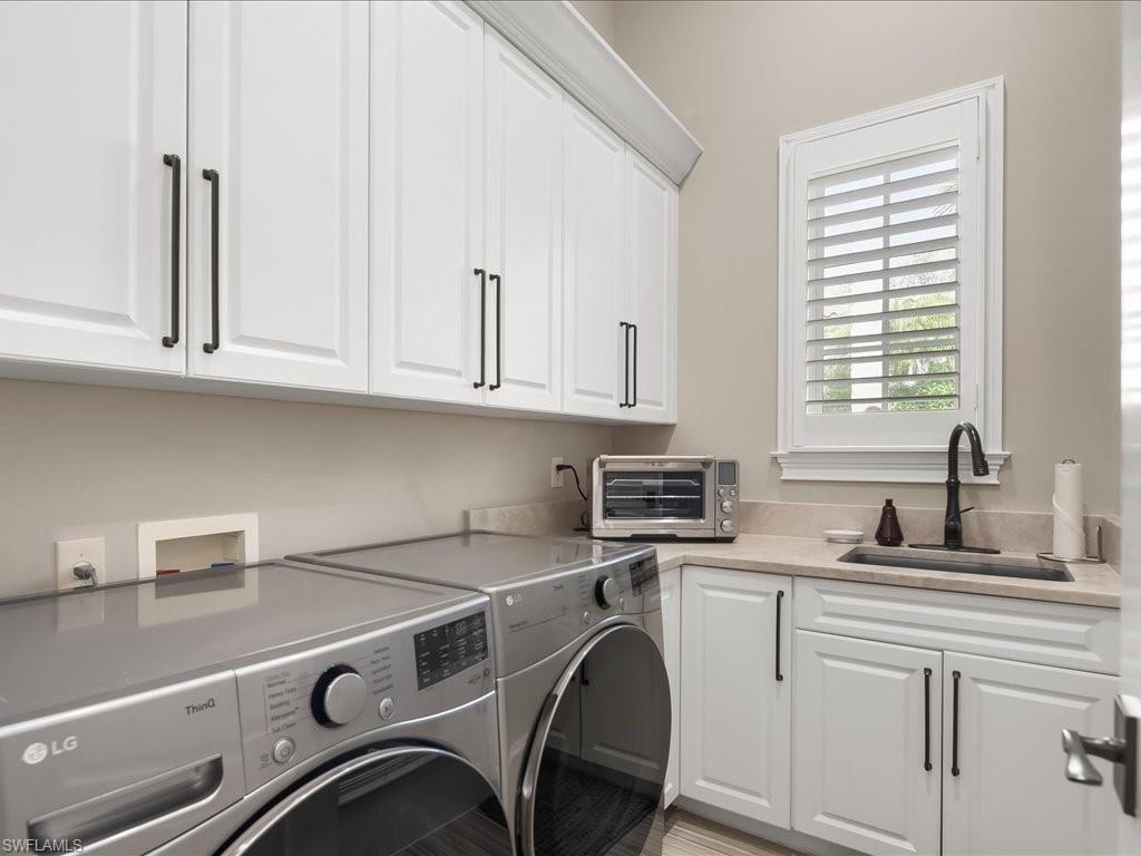 2822 Capistrano Way Naples, FL 34105 - Photo 33 of 47 Laundry room with upper cabinets and standalone sink.