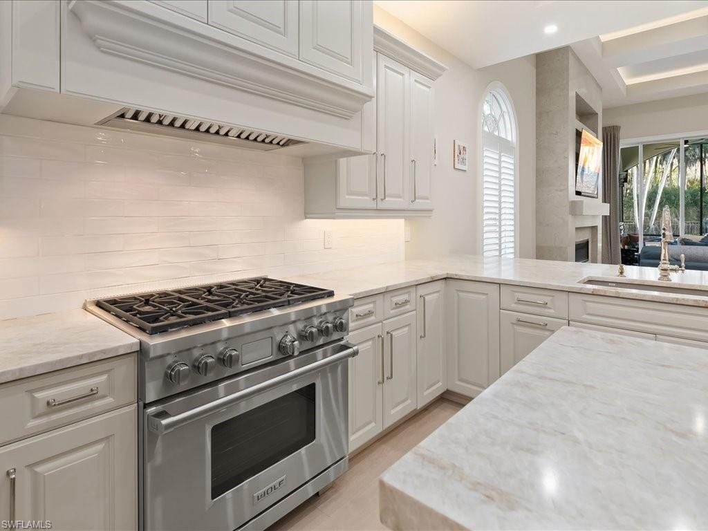 2822 Capistrano Way Naples, FL 34105 - Photo 6 of 47 Wolff Gas range with custom hood. Leathered Taj Mahal Quartzite countertops