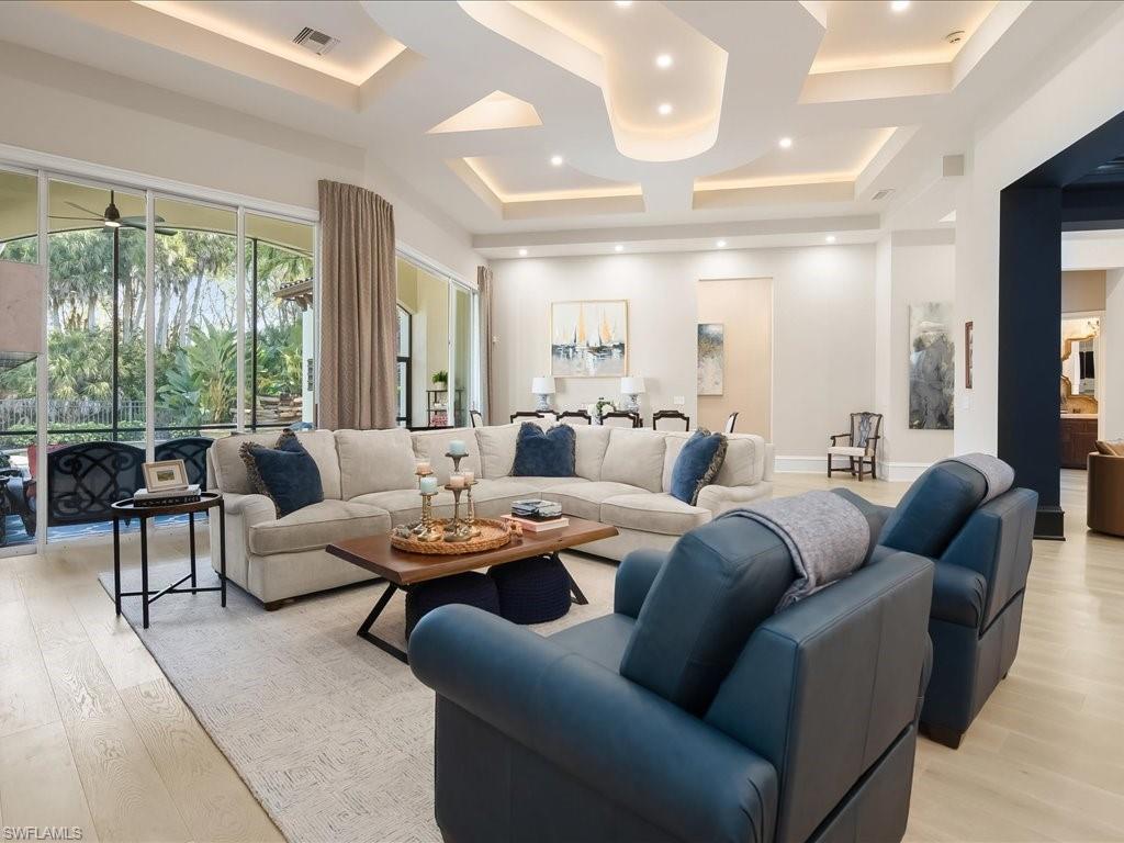 2822 Capistrano Way Naples, FL 34105 - Photo 10 of 47 Living area featuring European White Oak wood flooring, and dramatic ceiling details.