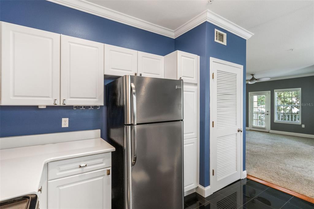 414 Water Street, Unit 414 Celebration, FL 34747 - Photo 14 of 75 a white refrigerator freezer and a stove sitting inside of a kitchen