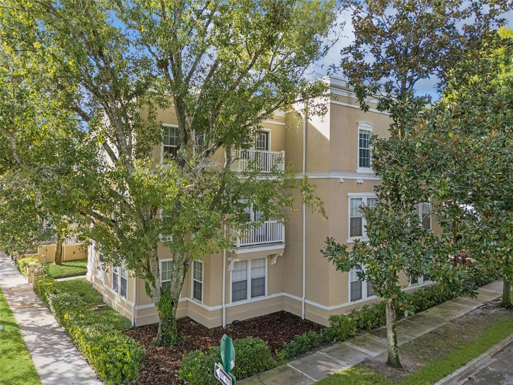 414 Water Street, Unit 414 Celebration, FL 34747 - Photo 2 of 75 a front view of a house with a garden