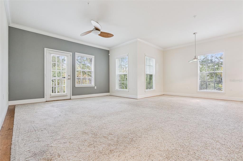 414 Water Street, Unit 414 Celebration, FL 34747 - Photo 23 of 75 an empty room with windows and ceiling fan