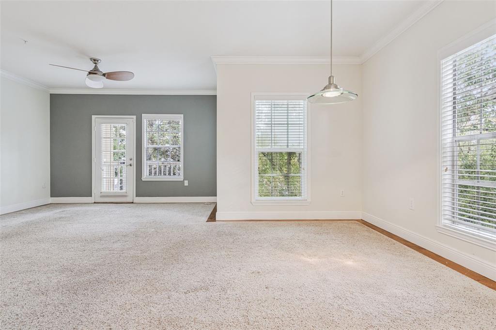 414 Water Street, Unit 414 Celebration, FL 34747 - Photo 24 of 75 an empty room with windows and chandelier fan