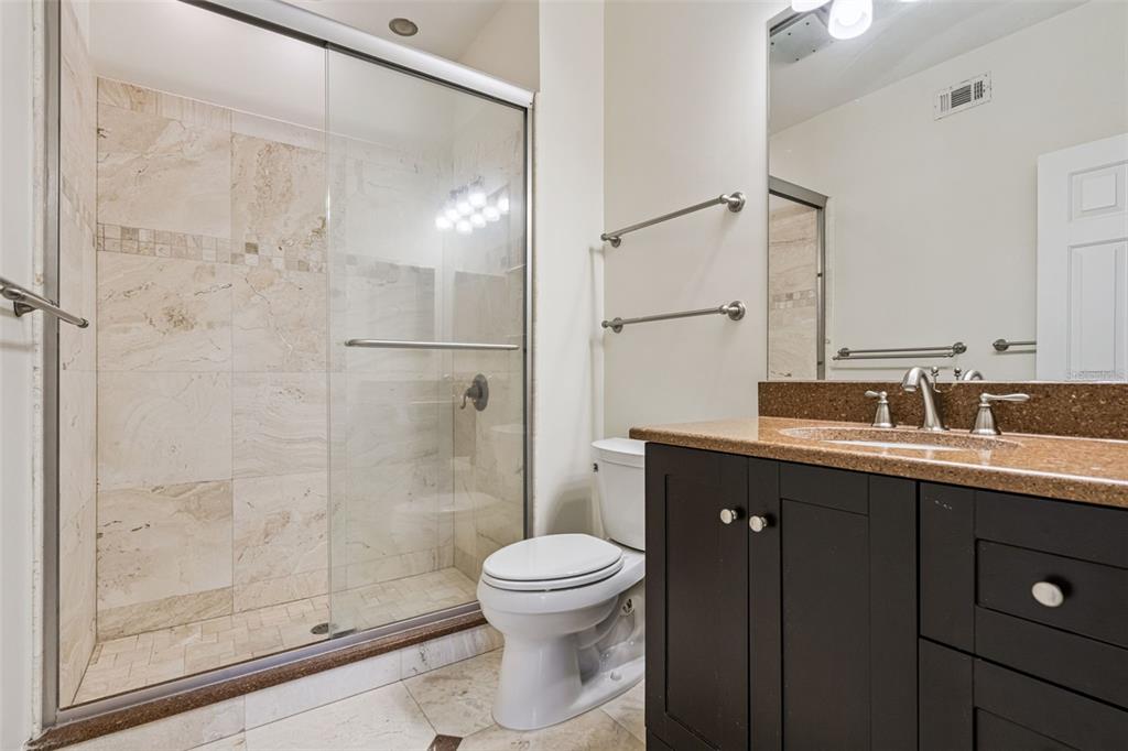 414 Water Street, Unit 414 Celebration, FL 34747 - Photo 31 of 75 a bathroom with a double vanity sink toilet and shower
