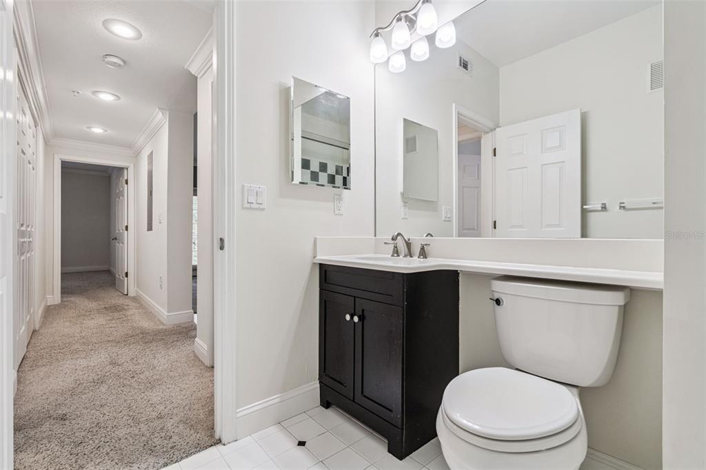 414 Water Street, Unit 414 Celebration, FL 34747 - Photo 39 of 75 a bathroom with a toilet shower sink vanity and mirror