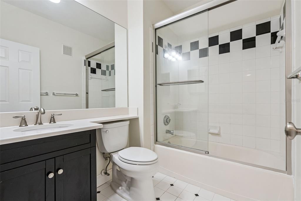 414 Water Street, Unit 414 Celebration, FL 34747 - Photo 40 of 75 a bathroom with a sink a toilet and shower