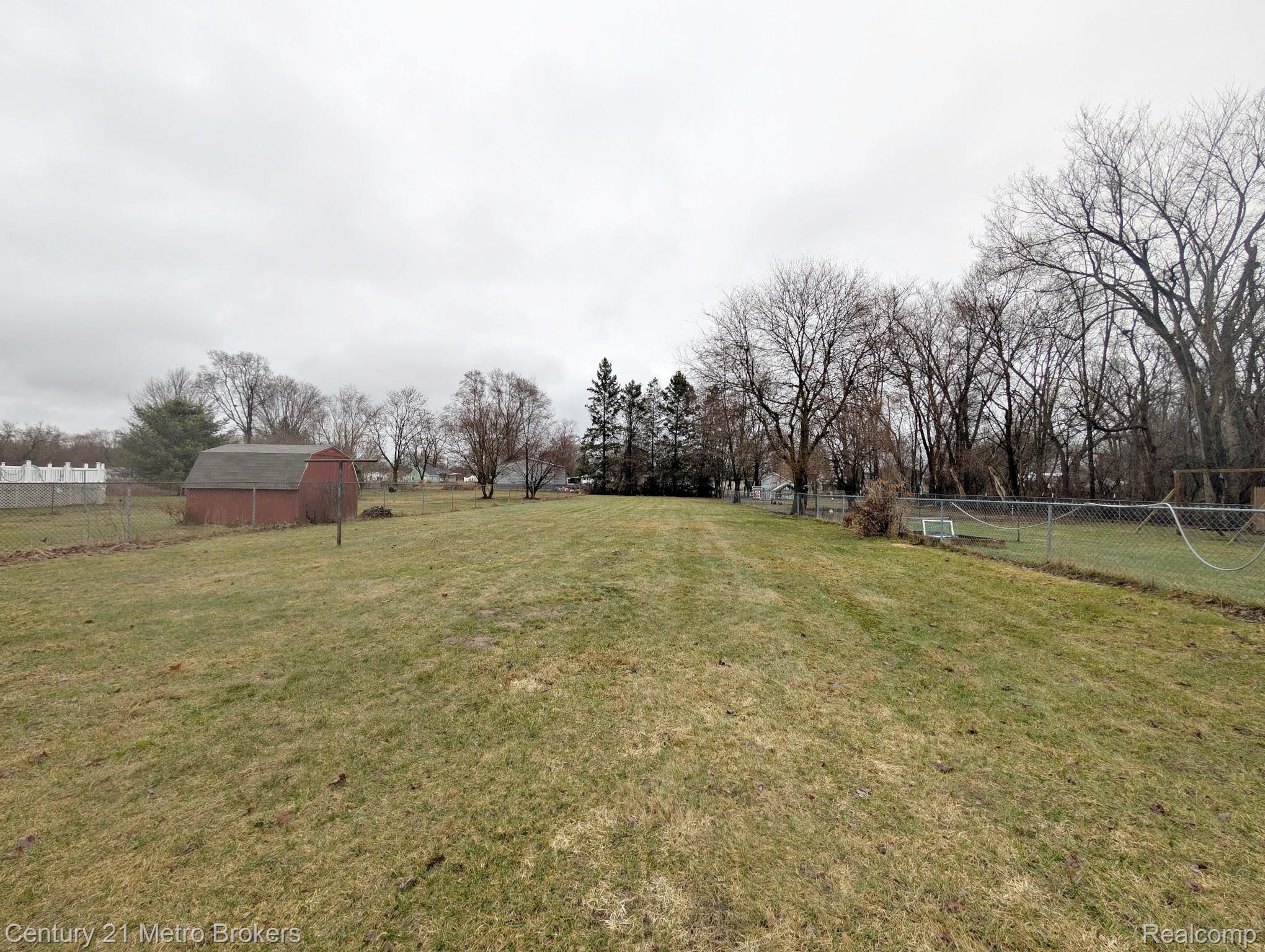 2074 North Center Road Burton, MI 48509 - Photo 17 of 20 View of yard with an outbuilding and a view of rural / pastoral area
