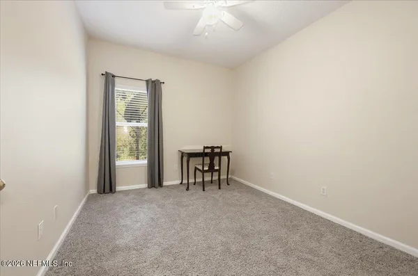 an empty room with windows and closet
