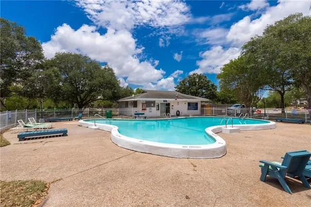 a front view of a house with a garden and trees