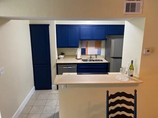 a kitchen with stainless steel appliances a sink and a refrigerator