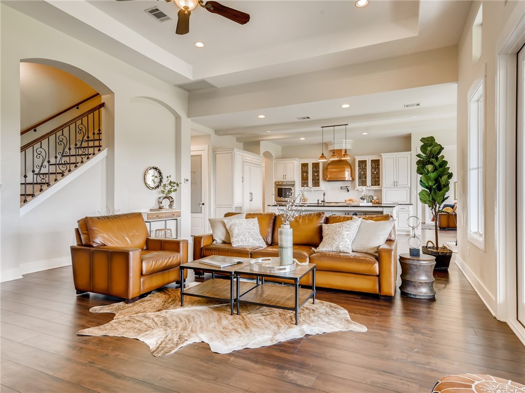 a living room with furniture and wooden floor