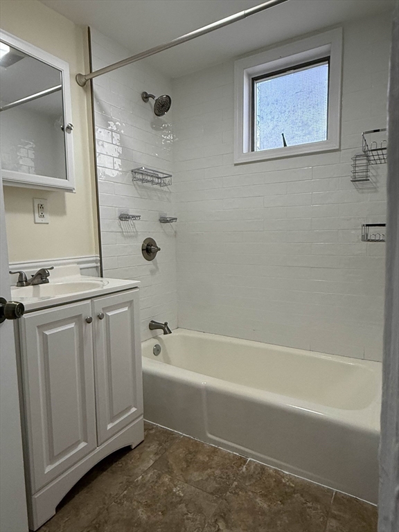 21 Flint Street, Unit 19 Somerville, MA 02145 - Photo 11 of 14 a bathroom with a tub a sink and a shower