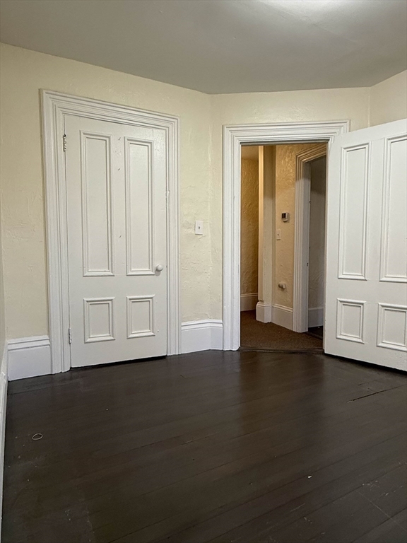 21 Flint Street, Unit 19 Somerville, MA 02145 - Photo 5 of 14 a view of empty room with wooden floor