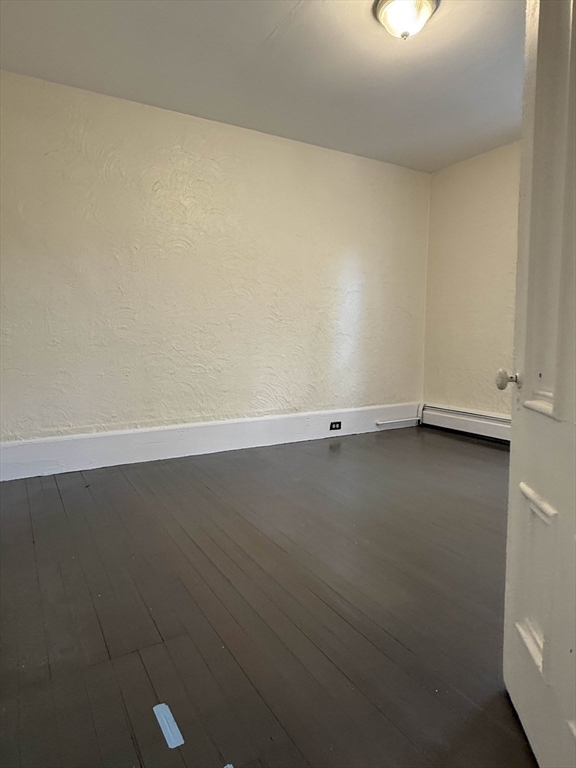 21 Flint Street, Unit 19 Somerville, MA 02145 - Photo 6 of 14 an empty room with a bench
