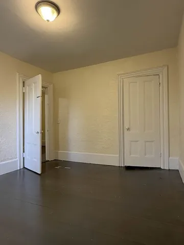 a view of an empty room and wooden floor