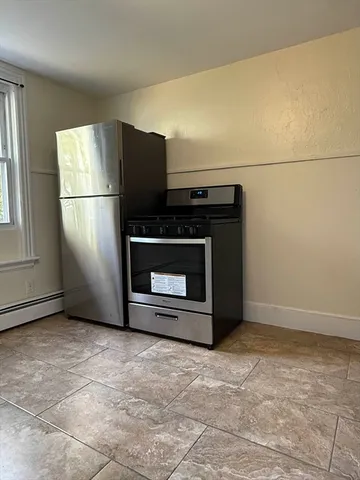a view of empty room with a fireplace