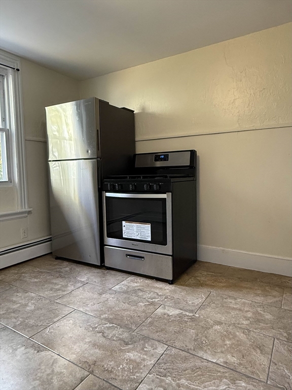21 Flint Street, Unit 19 Somerville, MA 02145 - Photo 9 of 14 a view of empty room with a fireplace