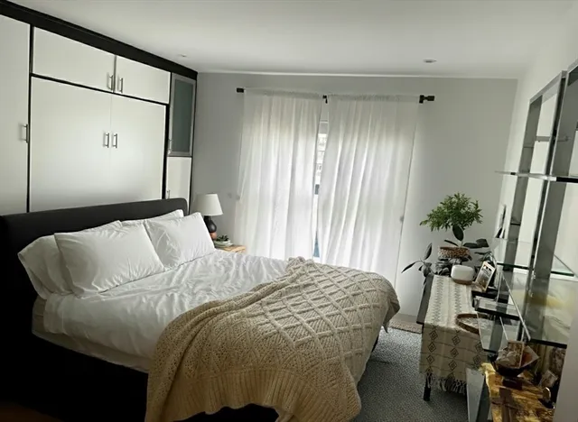 a bedroom with a bed and a potted plant