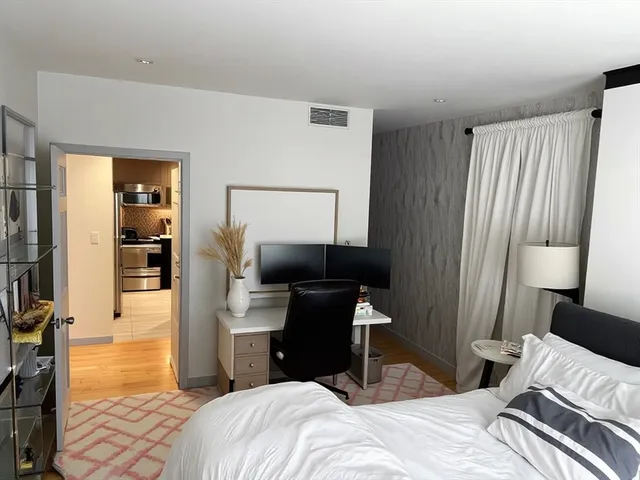 a bedroom with a bed and a mirror