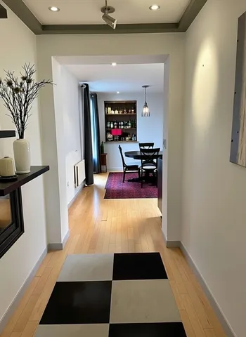 a hallway with furniture and a rug