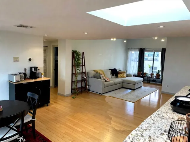 a living room with furniture rug and a table