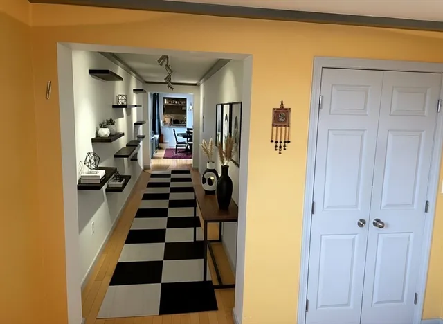 a view of a hallway with black white and white walls