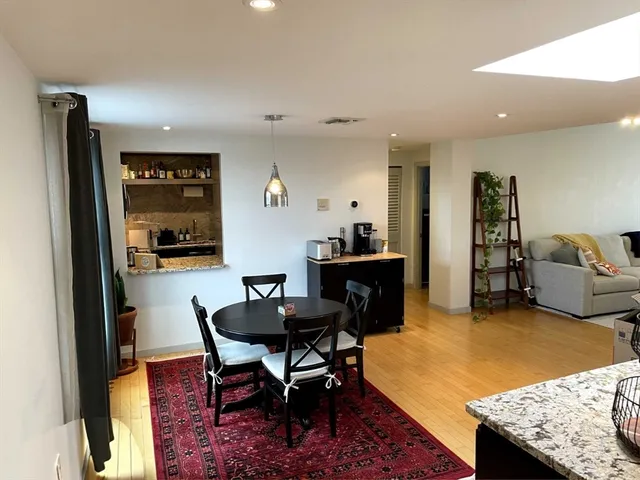 a view of a dining room with furniture and a rug