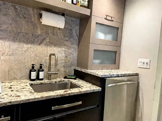 a kitchen with a stove and a sink