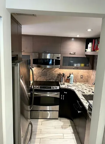 a kitchen with a stove and a refrigerator