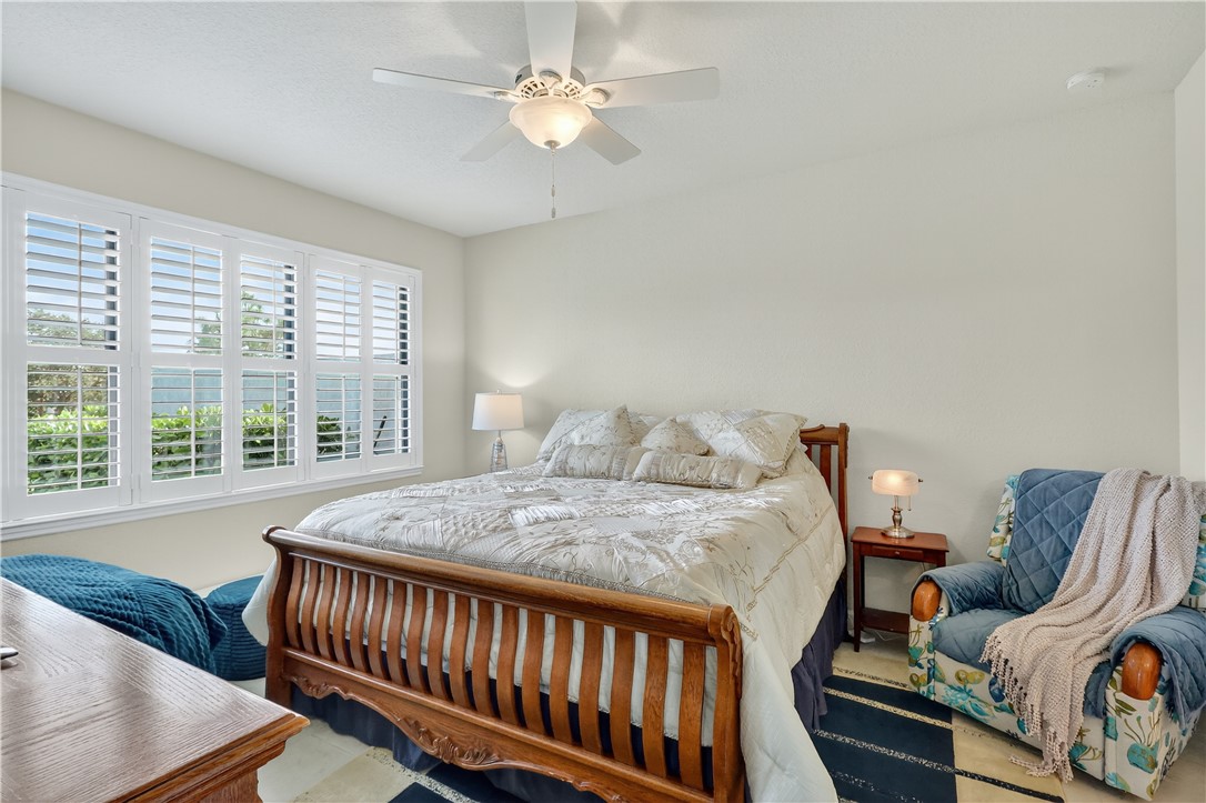5130 Unity Square Vero Beach, FL 32967 - Photo 11 of 36 a bedroom with a bed and a window